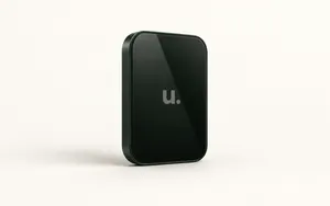 A dark green Unfinished app screen with the muted “u.” logo displayed on glossy black glass against a warm ivory background.