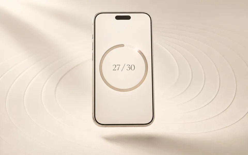 Ivory smartphone showing 27 of 30 progress with a nearly completed circular ring, floating above a cream surface with subtle concentric ripples.