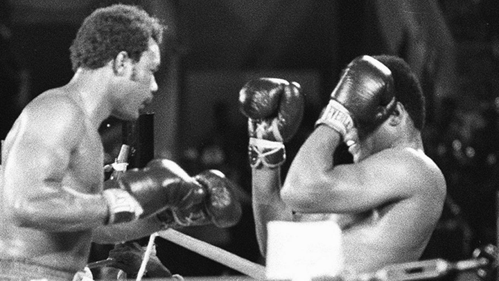 Image of Muhammad Ali leaning against the ropes during his fight with George Forman
