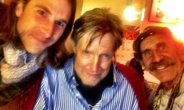 webcam photo of three men smiling at the camera