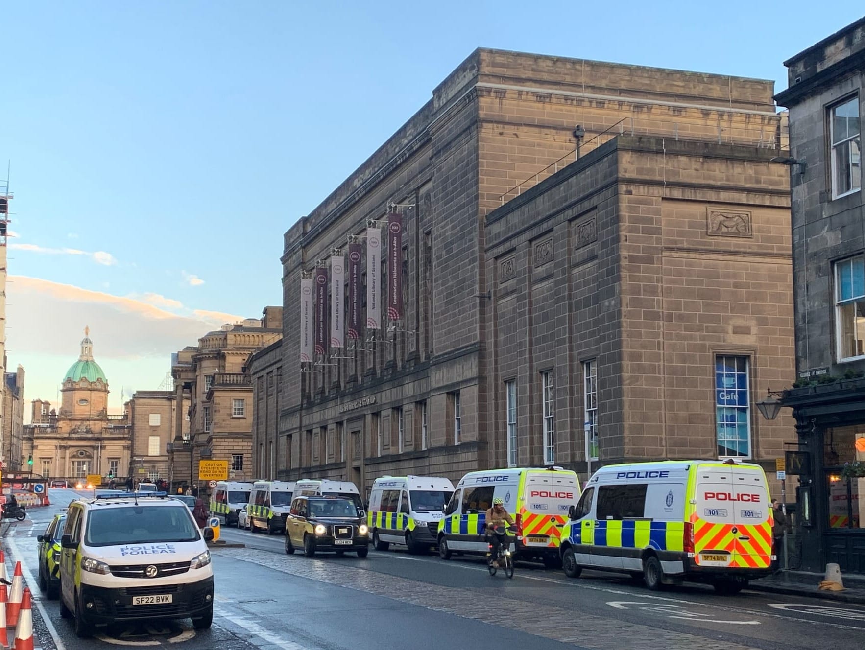 The National Library of Scotland buidling in Edinburgh protected by police vans. 