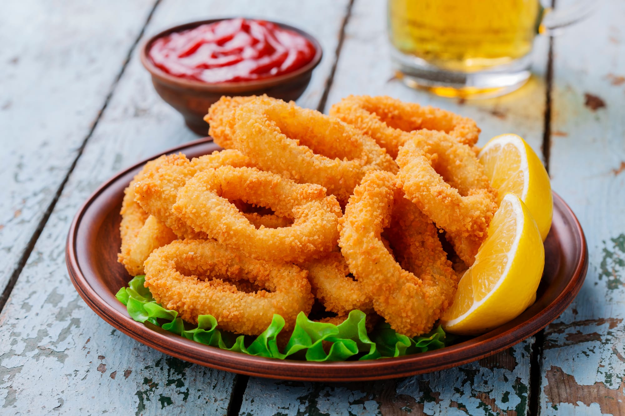Deep fried calamari with lemon and ketchup.