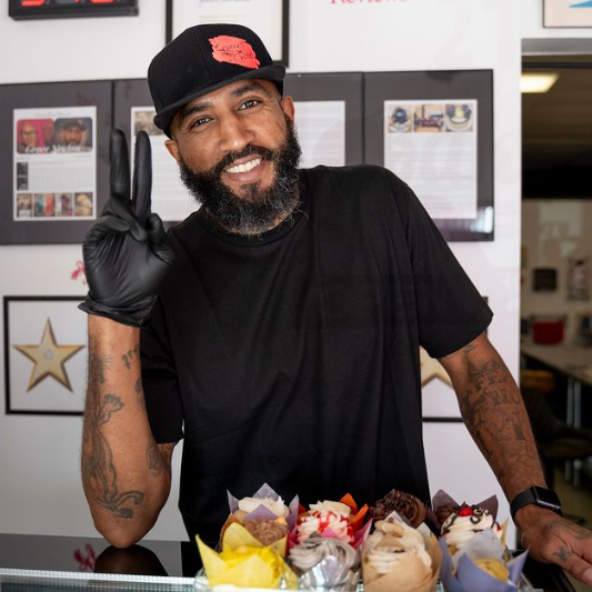 Curtis Nash with customized cupcakes at the bakery.