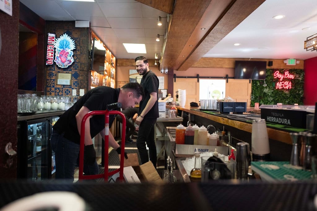 Restaurant staff behind the bar