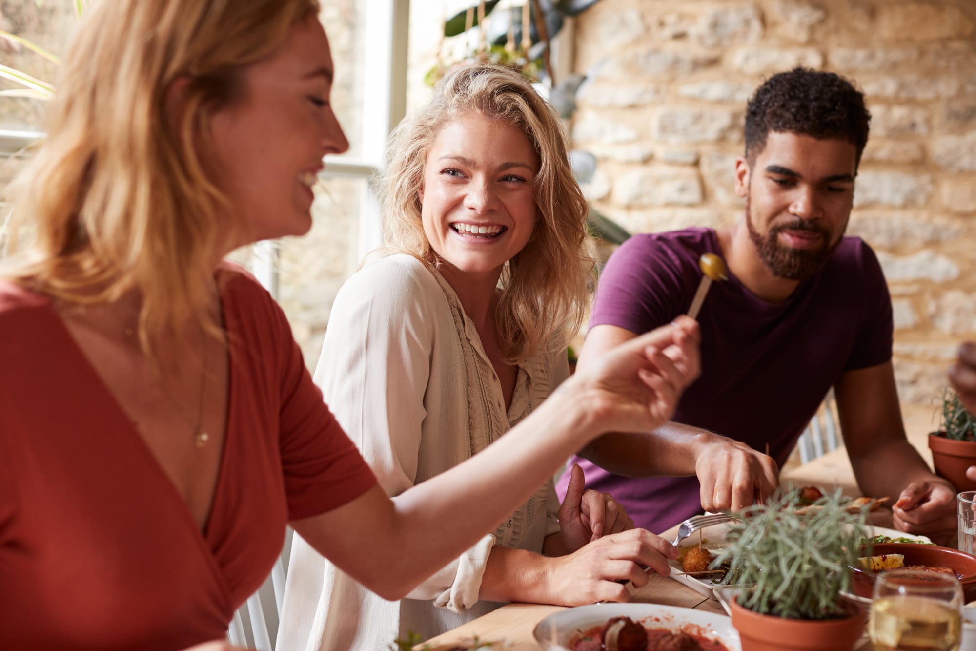 Guests sharing Spanish olives and other tapas at a tapa bar.