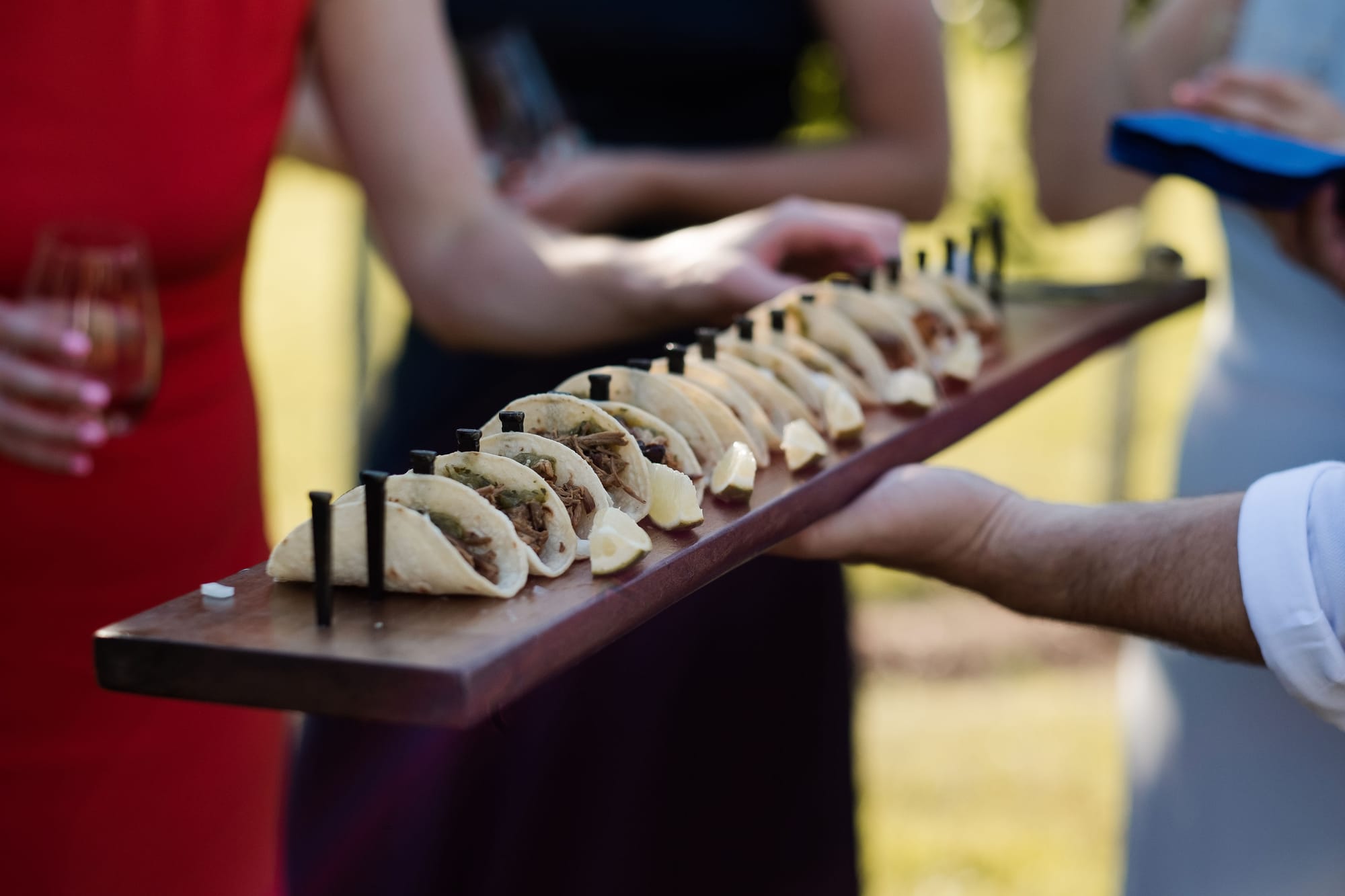 Line of al pastor tacos at a dinner party or taco Tuesday.