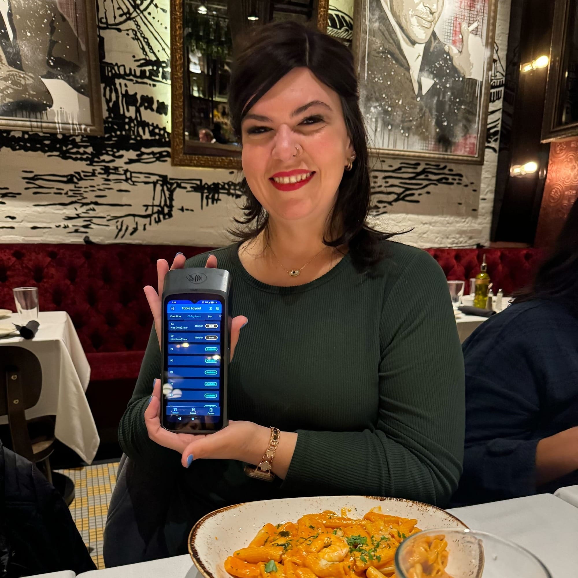 Lindsey with a SpotOn Handheld at a restaurant.