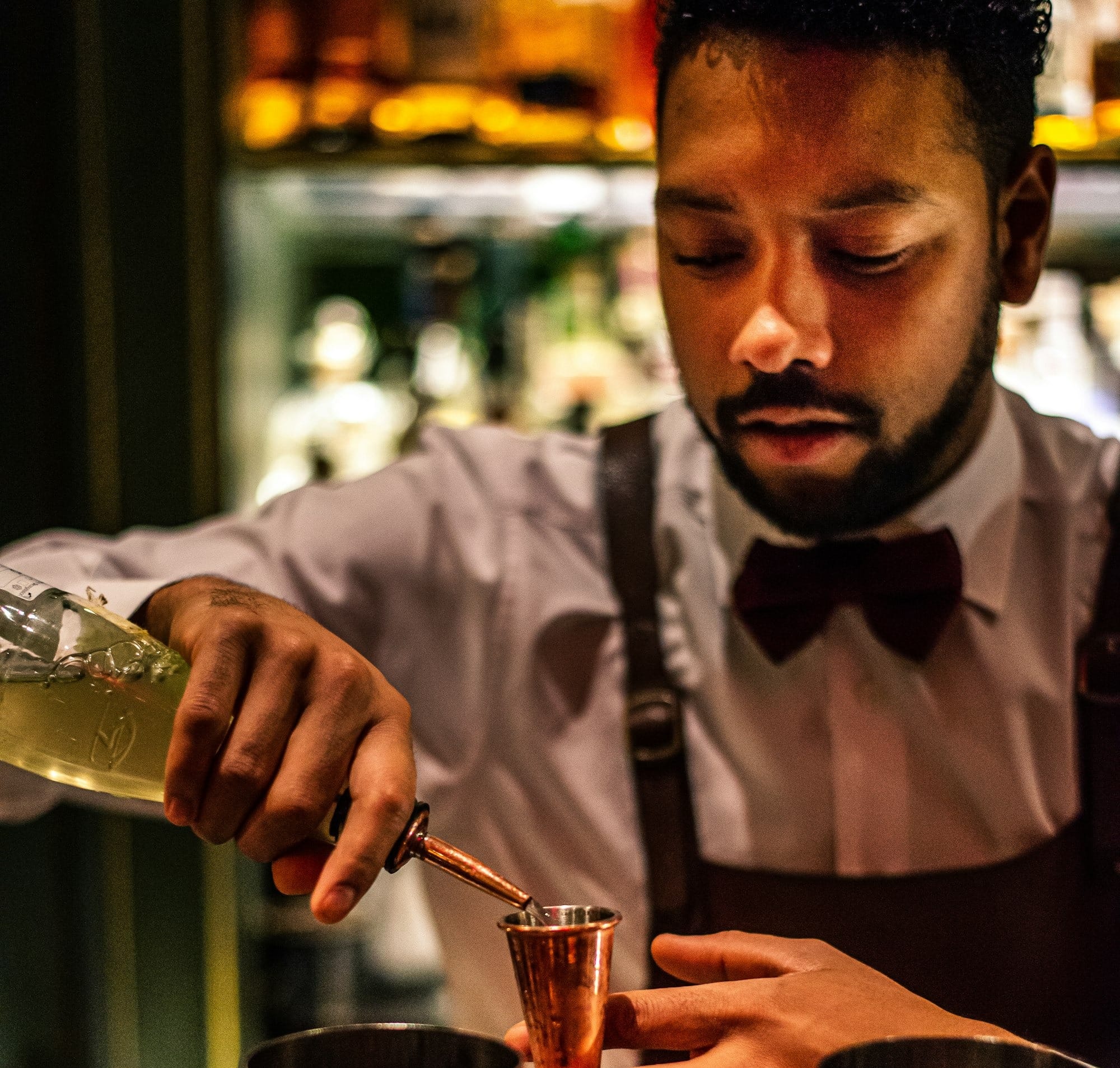 A bartender prepares a drink