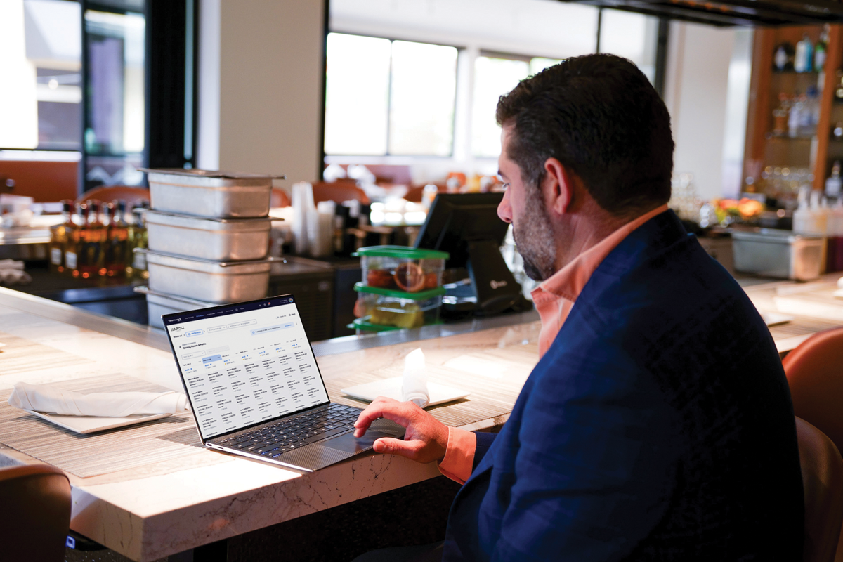 Restaurant manager looking at the employee schedule at the bar.