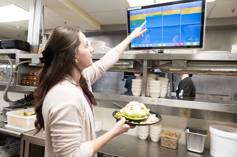 An expo checking the KDS for the next order to run.