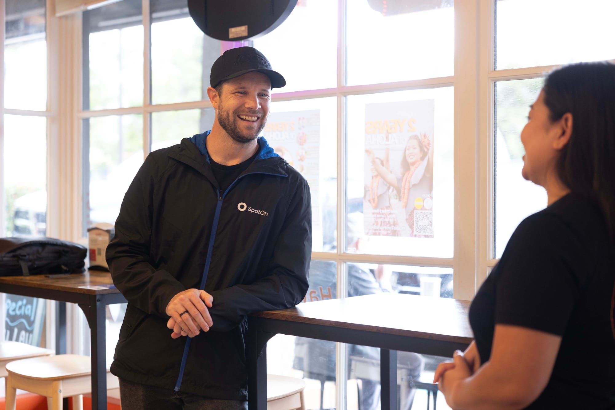 A local SpotOn representative helps a restaurant owner with their new POS