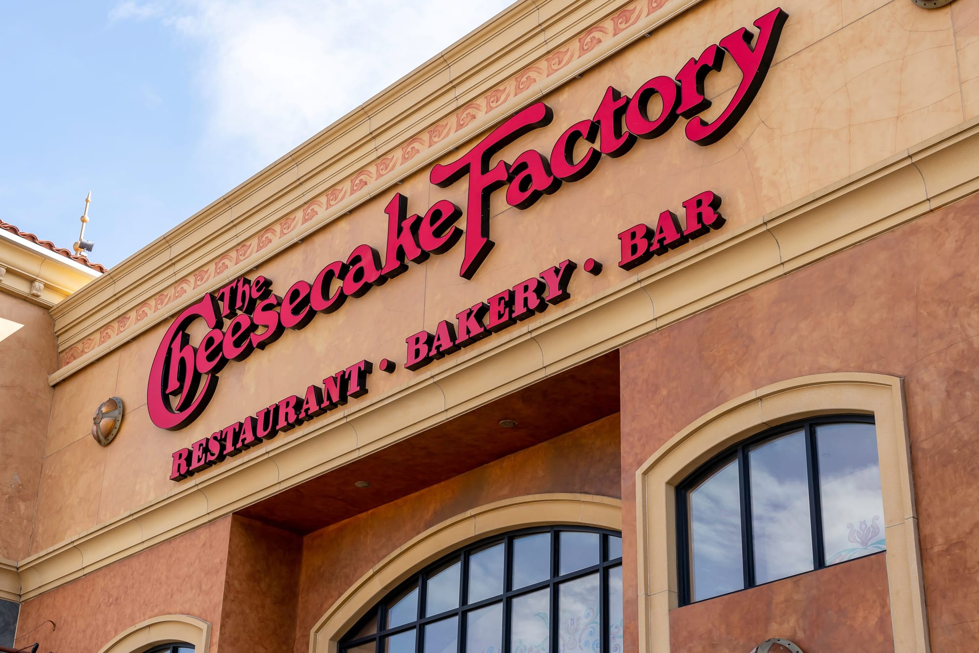 Close-up of the Cheesecake Factory sign on a restaurant building in Buffalo