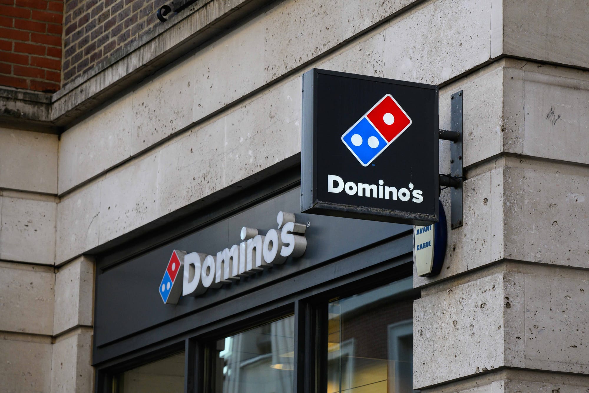 Close-up of Domino’s fast food pizza store sign with logo