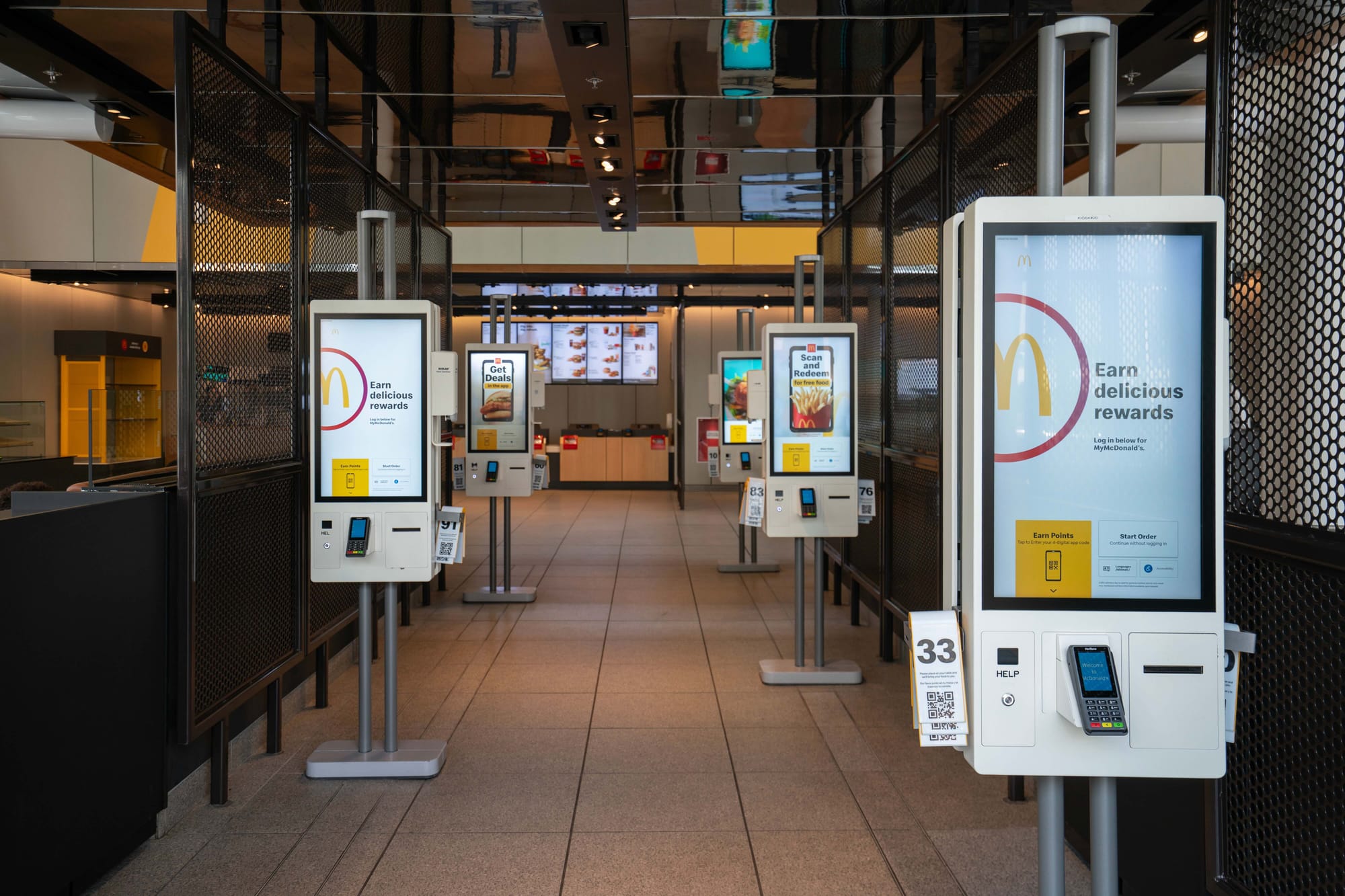Self-service kiosks in a modern McDonald’s restaurant interior