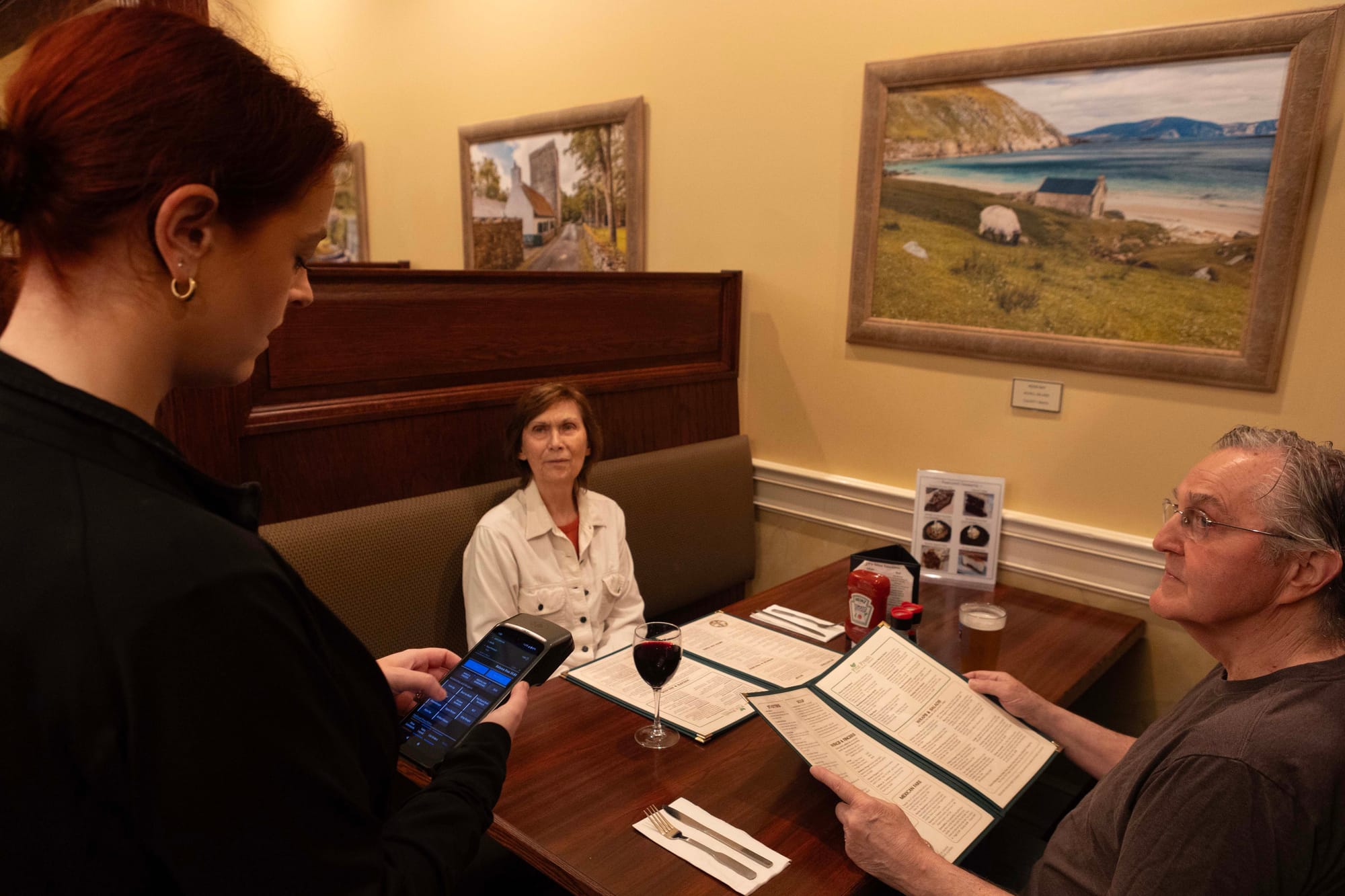 Server taking an order with a handheld.