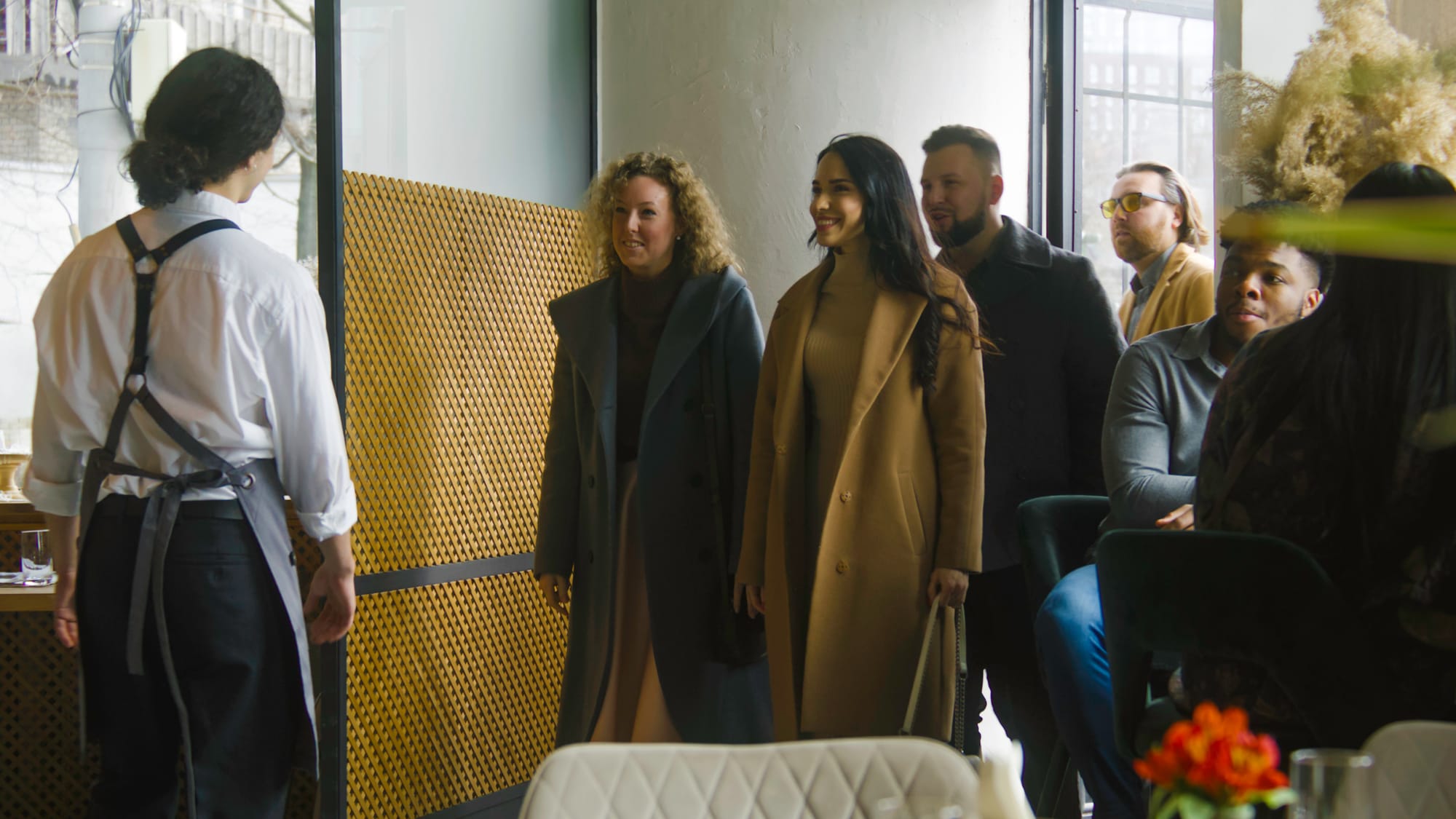 Host greeting a party walking into a restaurant