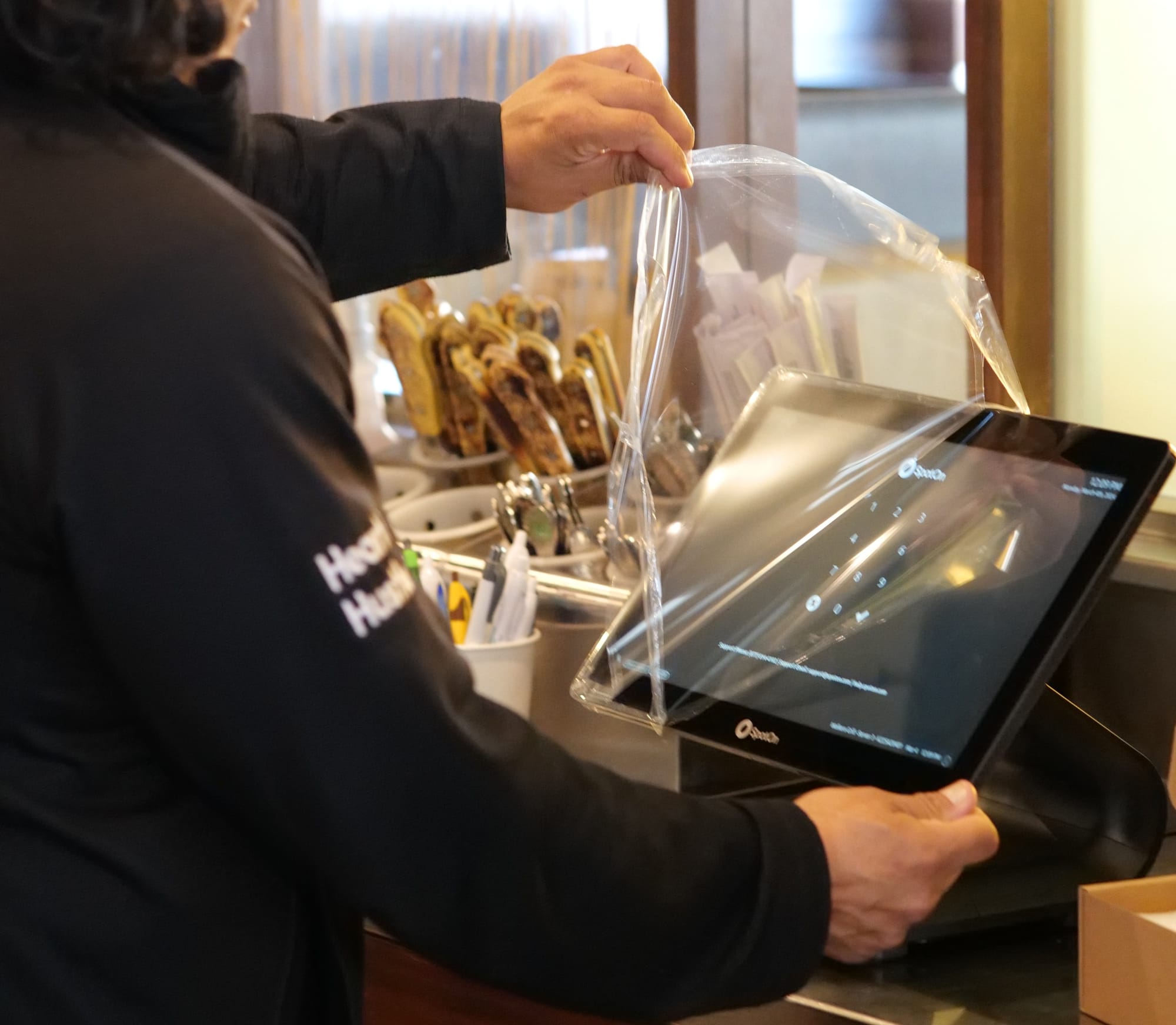 A SpotOn implementation expert installs new POS hardware at a retaurant