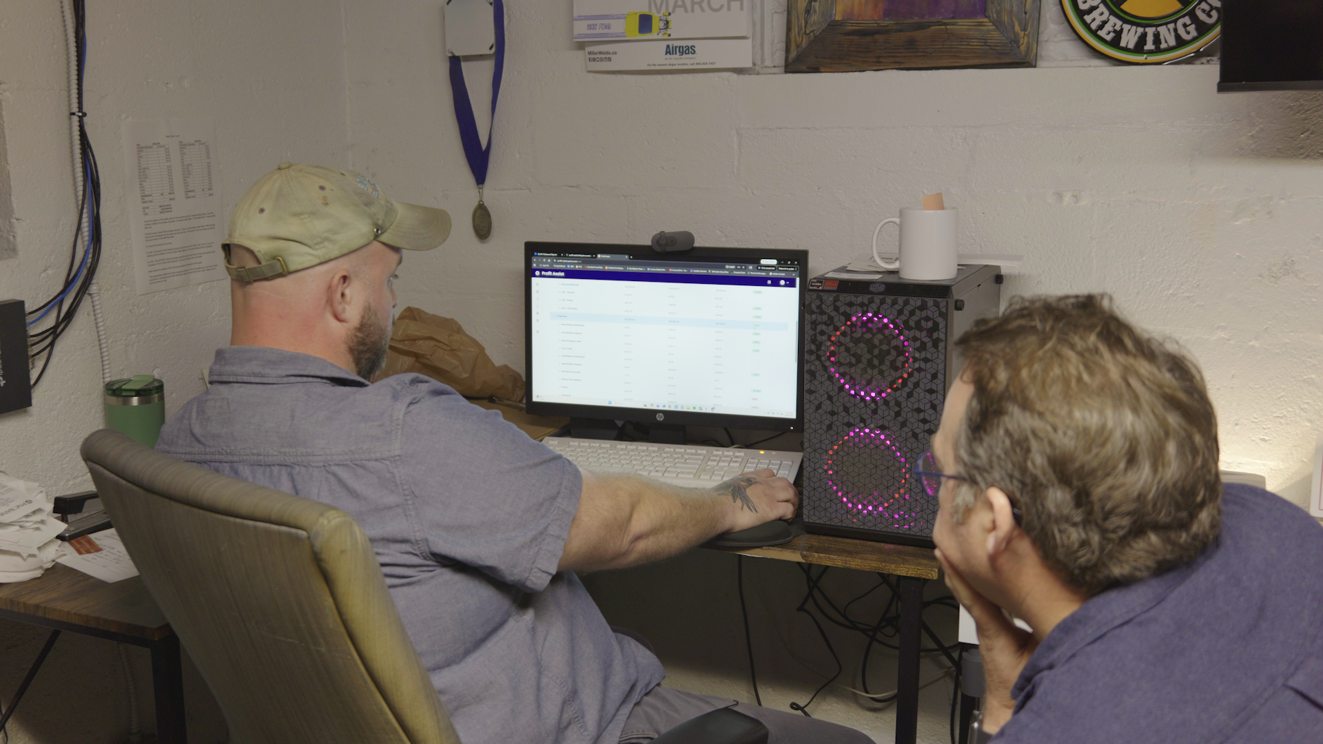 Butcher Paper BBQ owner Mark Coxwell and SpotOn Restaurateur-in-Residence Scott Youkilis examine sales numbers.