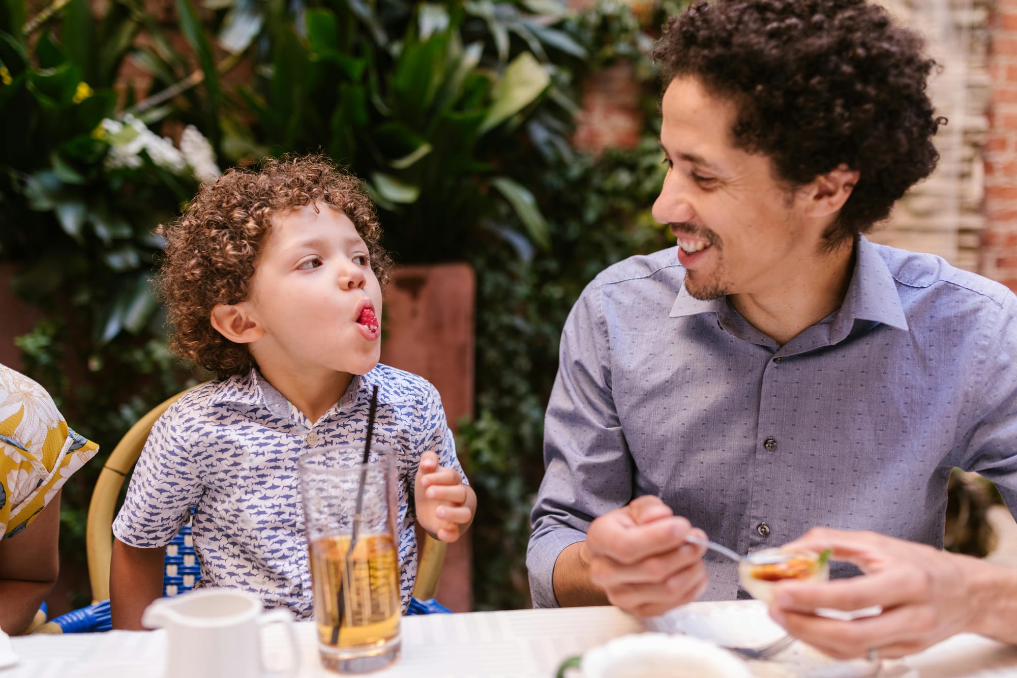 A family enjoying a meal together, celebrating Father's Day with discounted meals.