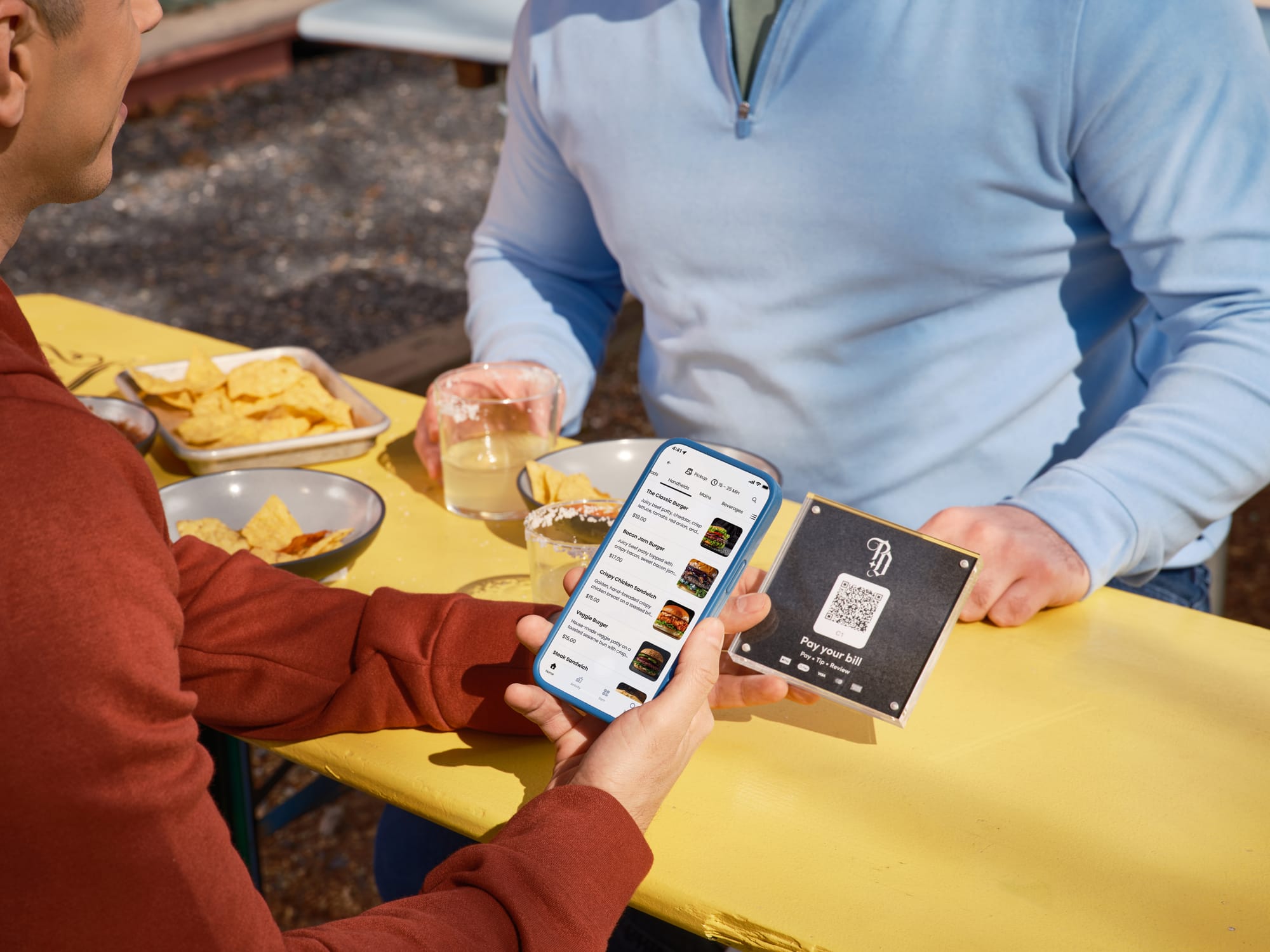 A restaurant guest scanning a QR code to access a digital menu on their phone.