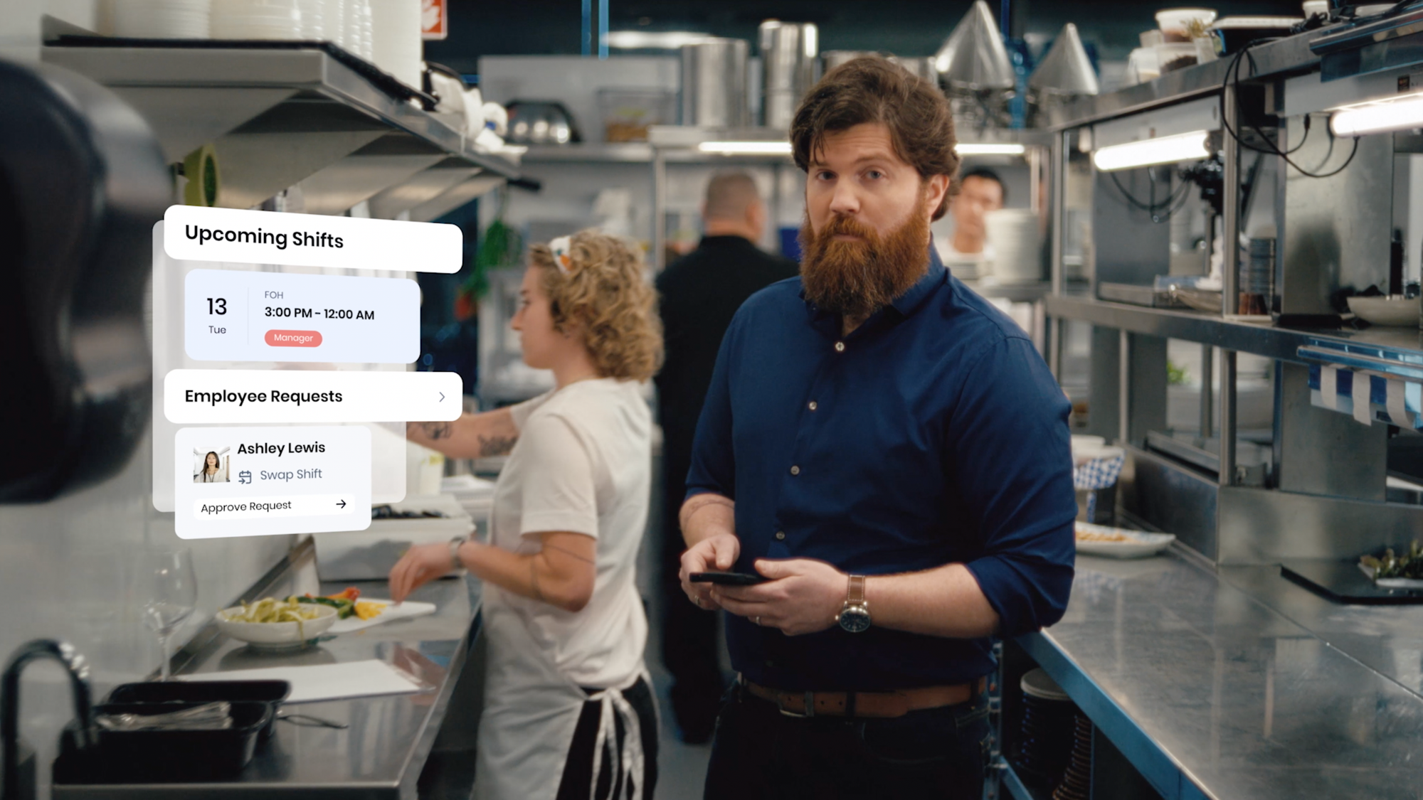 A restaurant team member holds a phone in a busy kitchen, with an overlay of the Teamwork by SpotOn app showing upcoming shifts and an employee shift-swap request.