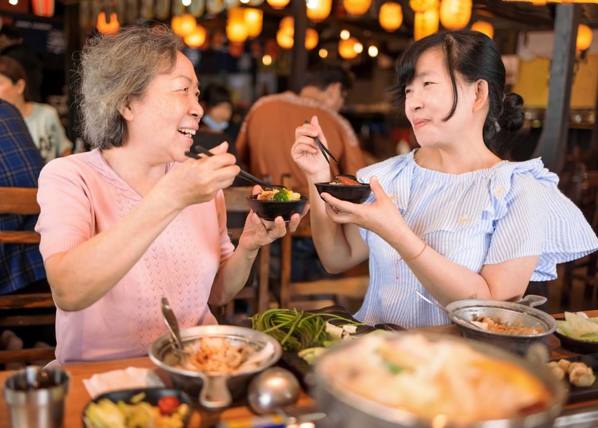 A woman and her mother enjoy a Mother's Day meal at a restaurant