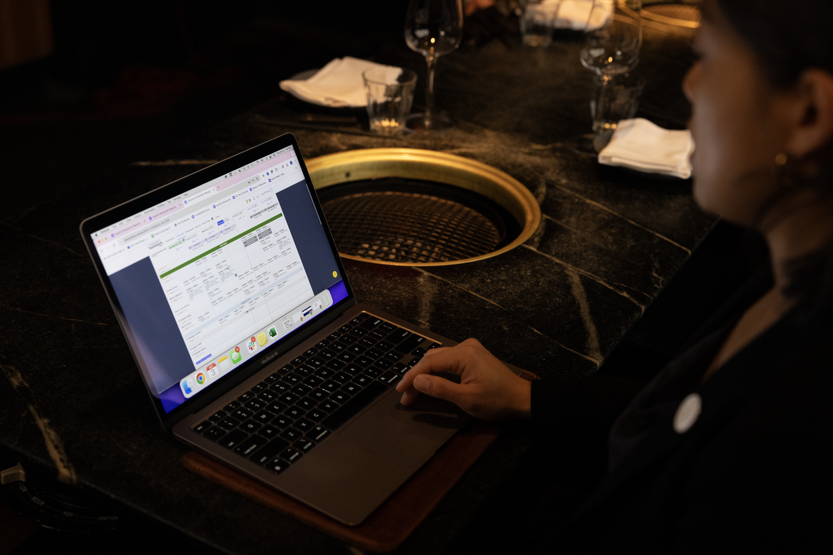 A restaurant operator reviews a restaurant AI-powered tool on their laptop