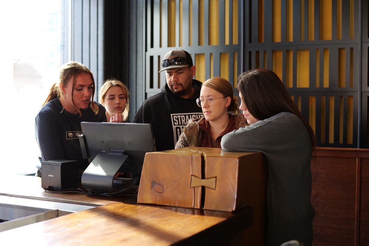 A POS implementation expert trains restaurant staff on their new SpotOn POS