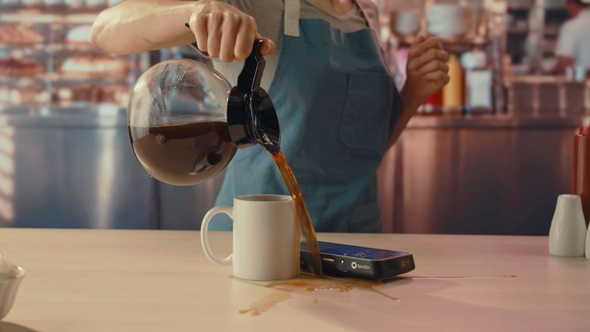 A SpotOn Handheld POS device gets coffee poured on it, part of the "Drop the Beat" video showing how durable the handheld is