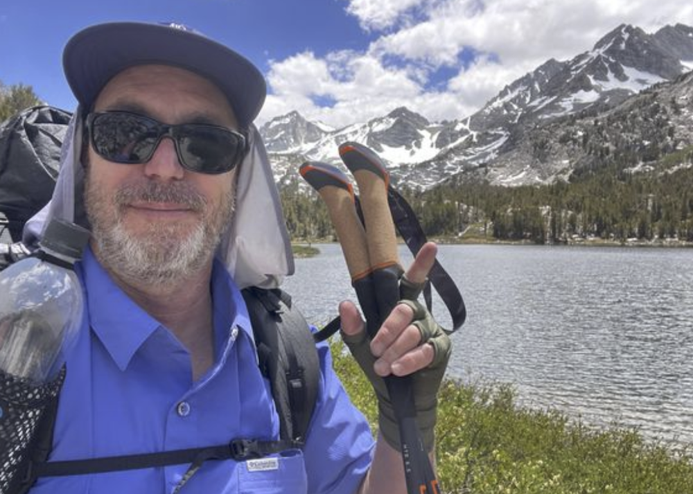A man uses LEKI's Makalu Trekking Poles on a mountain hike