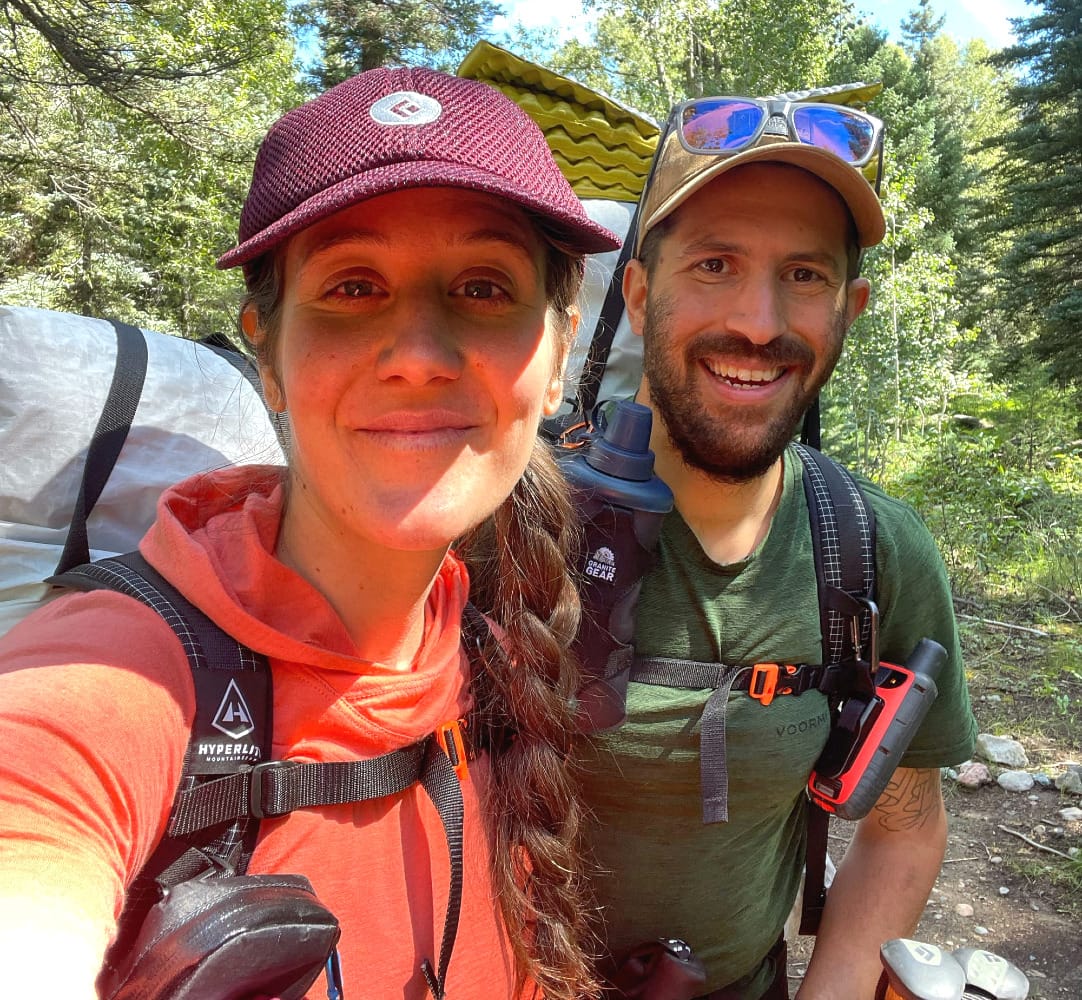 Hikers wearing a Hyperlite Southwest 70 Backpack on a mountainous canyon trail.
