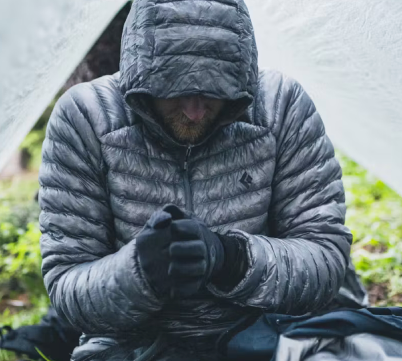 deploy down hoody by black diamond on a man camping