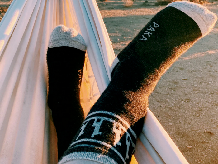 a hiker relaxing in a hammock during an adventure in the paka costa hiking socks in the woods showing a pair of 2026 best socks