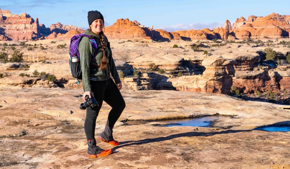 a woman wearing the hoodie alpaca wool hoodie by PAKA in the high desert of the southwest on a hike.