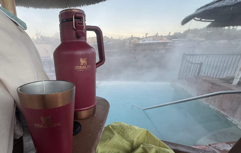 The Classic Easy-Pour Growler 64oz By Stanley sitting near a natural hot spring in southwest colorado on a cold day