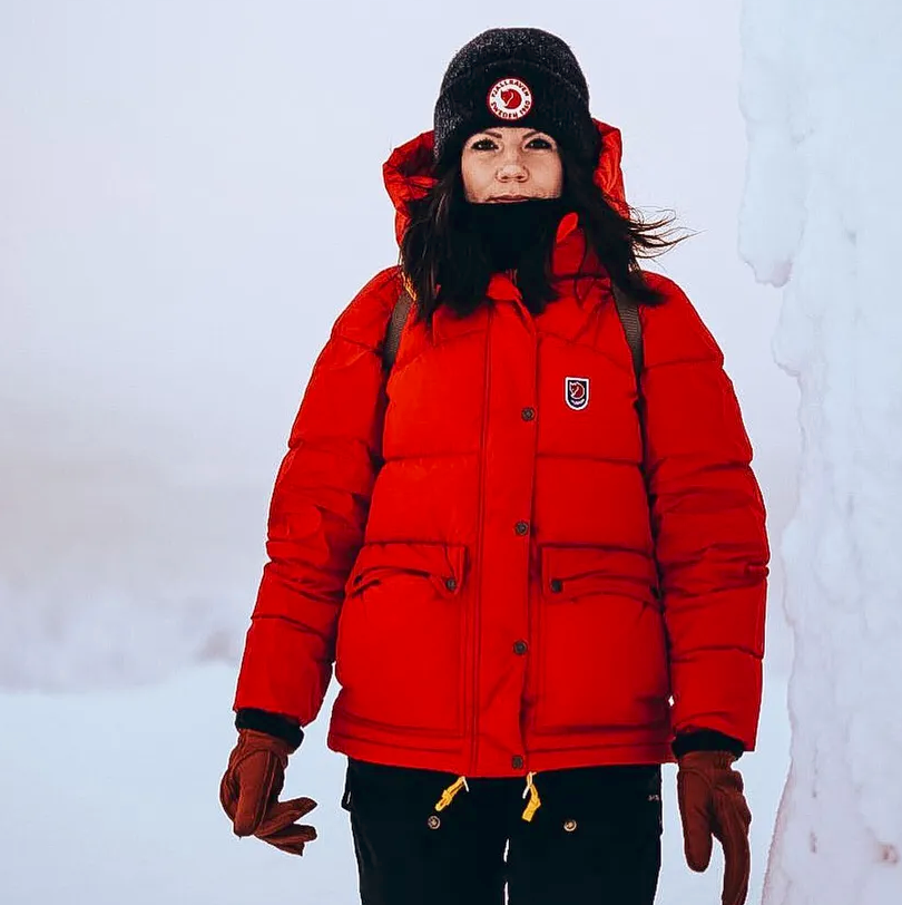 a hiker wears the burliest 2025 pick, the fjallraven expedition down lite jacket in the arctic for a frigid adventure