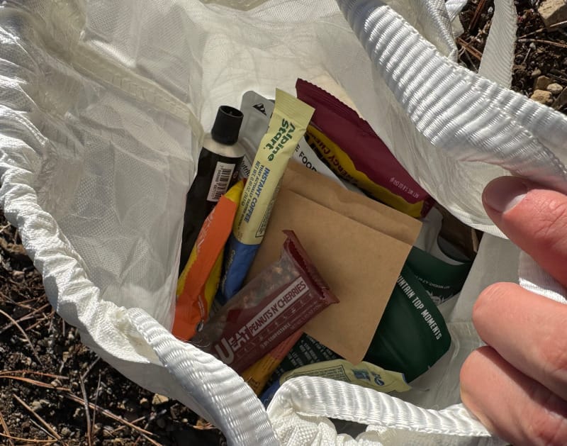 the gear ultralight food locker that is grizzly proof by adotec gear full of food on a backpacking trip