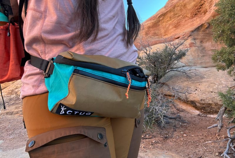 a backpacker wears a custom made hip pack that is ultralight and full customized