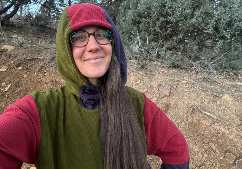 a woman wears a sambob custom hoodie on a big hike in the high desert of the southwest