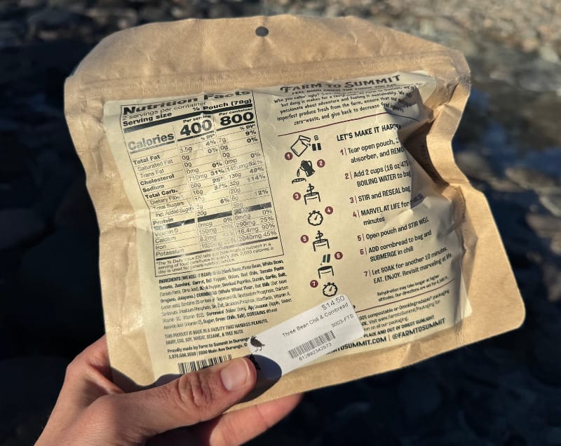 the nutrition information and packaging of a farm to summit dehydrated meal along a mountain creek.