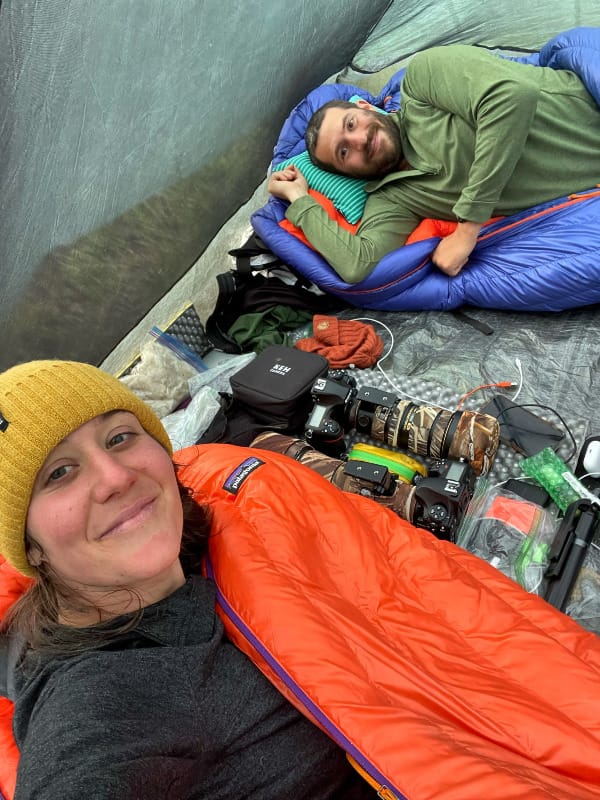 two campers in the UltaMid 4 Ultralight Pyramid Tent By Hyperlite Mountain Gear with all their gear