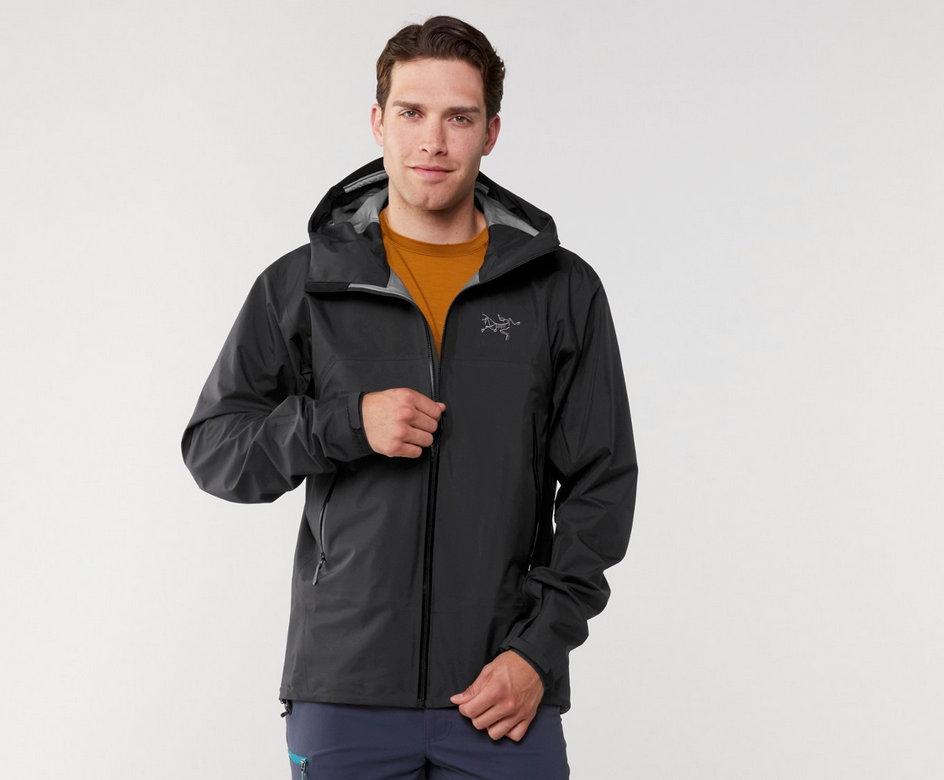 Man wearing the Arc'teryx Beta SL Hybrid rain jacket in charcoal gray, ideal for serious hikers and backpackers.