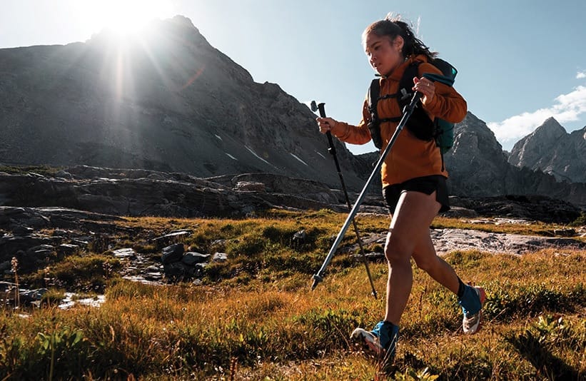 a trail running thru hiker wearting Kahtoola INSTAgaiter SL Minimalist Gaiters in the mountains on a grand adventure