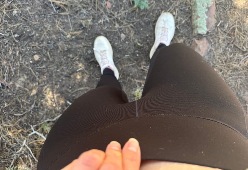  Top-down view of Ibex Enduro Tights waistband worn during hiking, showcasing fit and comfort.