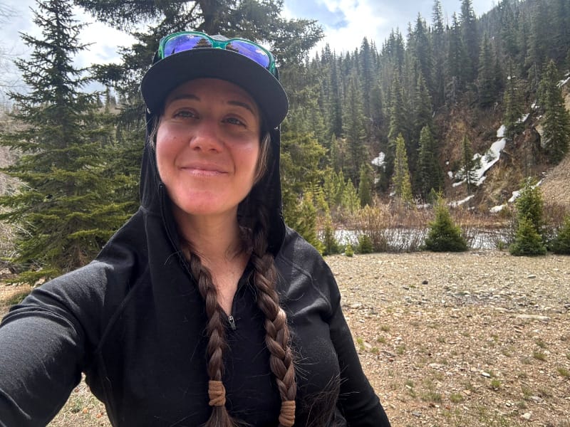 A women hikes in a black ibex indie hoodie in the colorado mountains.