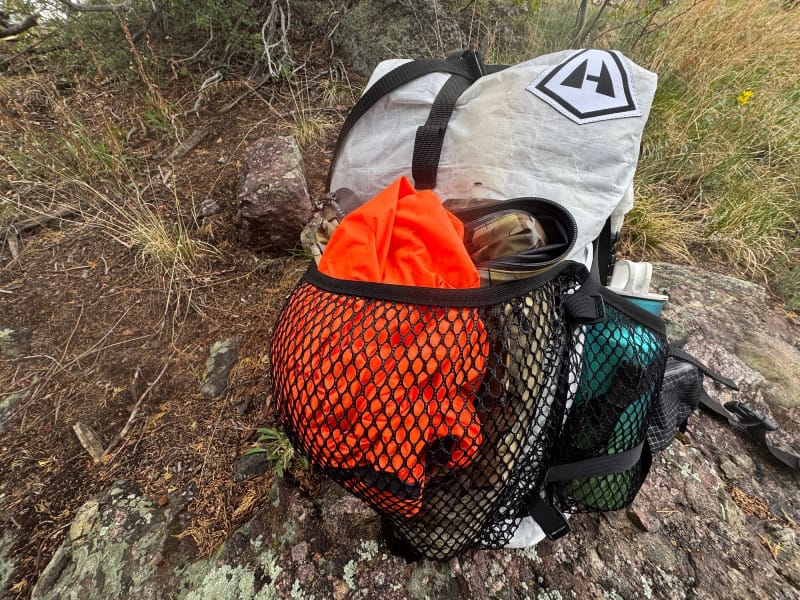  Front view of the Hyperlite Mountain Gear Windrider 40 backpack, featuring roll-top closure and large black mesh front pocket.