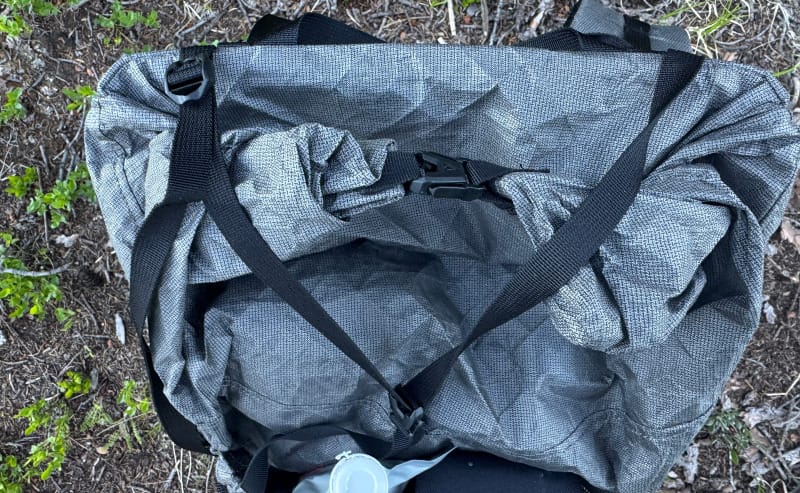  Top-down view of Durston Kakwa 55 showing the roll-top closure and Ultra200X fabric in a forested camp area.