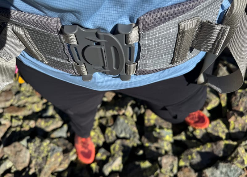  Aarn Mountain Magic 50 Pro backpack on hiker standing among alpine rocks, testing performance on rugged trail