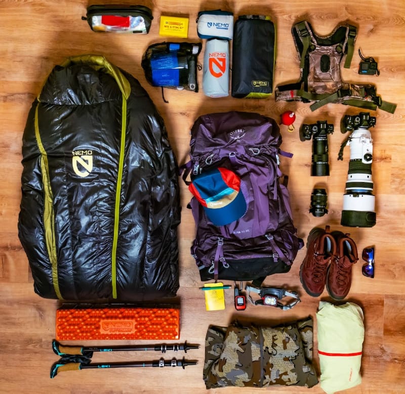 a flat lay of backpacking gear to plan how to pack your backpack as a beginner.