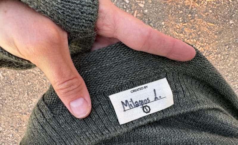 Close-up of the PAKA Women’s Hoodie interior tag with artisan’s signature.